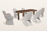 Gaiole 7-piece dining set, three-quarter view on a warm white studio backdrop: a freeform solid mango table in dark walnut