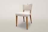Galen herringbone dining chair in Sandy Beige, three-quarter view on a warm off-white studio backdrop