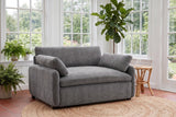 Gallipoli chair in charcoal gray on a jute rug in a Victoria garden room with ferns and tall paned windows
