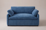 Gallipoli chair in denim blue, straight front view: one wide seat cushion, one back cushion, a pillow on each low rounded arm