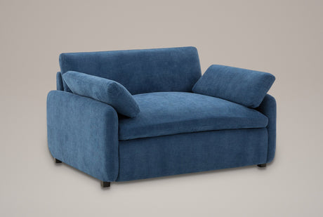 Gallipoli oversized chenille accent chair in denim blue, three-quarter view on a warm grey studio backdrop