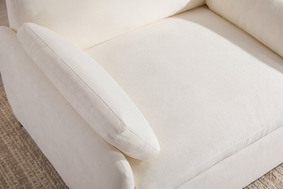 Close-up of the ivory chenille seat cushion, a throw pillow and the rounded arm
