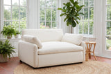 Gallipoli chair on a jute rug in a Victoria garden room with ferns and tall paned windows