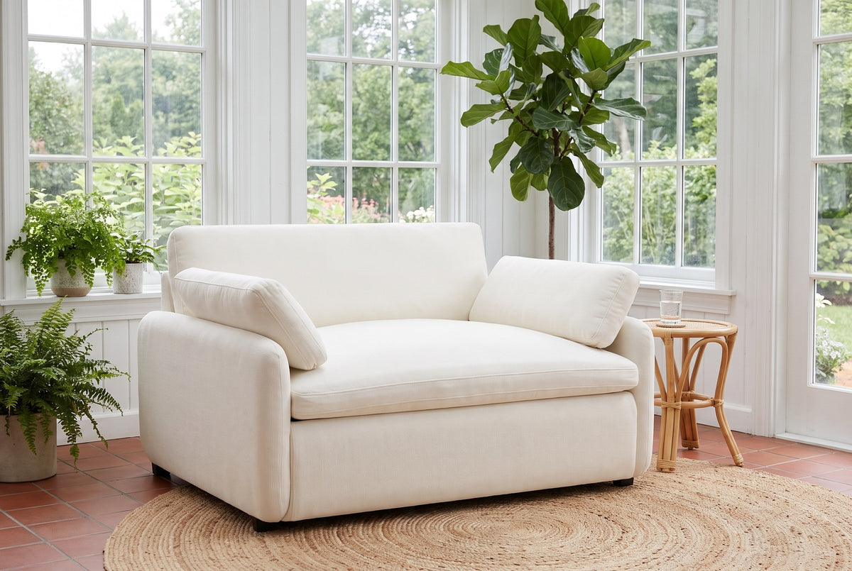 Gallipoli chair on a jute rug in a Victoria garden room with ferns and tall paned windows