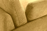 Close-up of the ribbed mustard yellow chenille where the arm, the back cushion and a pillow meet