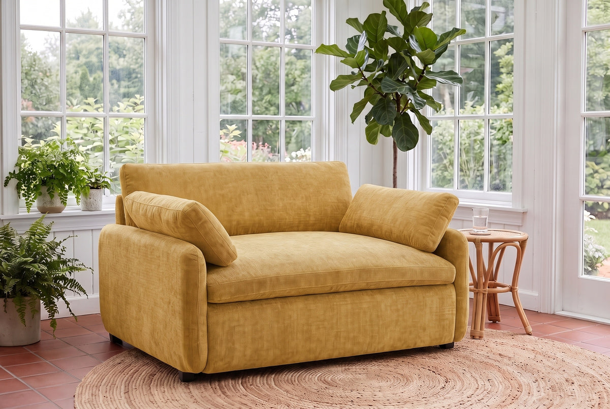 Gallipoli chair in mustard yellow on a jute rug in a Victoria garden room with ferns and tall paned windows
