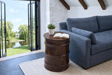 Gangi side table in Walnut seen from above beside a slate-blue linen sofa in a Merrickville stone house