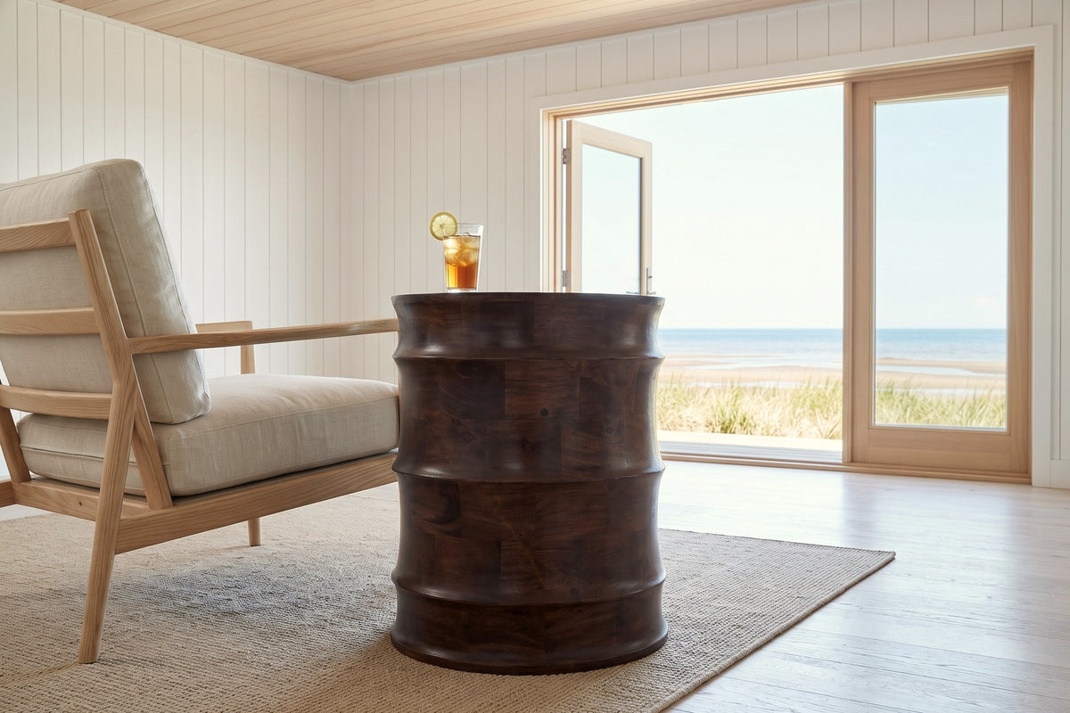 Side view of the Gangi side table in Walnut beside an ash lounge chair in a Shediac beach house, with white board walls