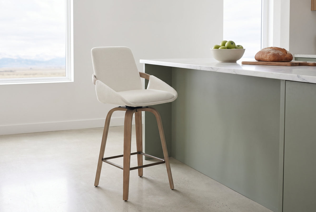 Gardone counter stool in ivory beside a sage-green kitchen island with a white marble top in a bright Calgary kitchen