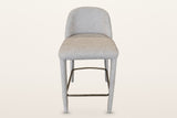 Gavi counter stool in beige, straight front view: the low rounded back, the thick seat