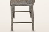 Gavi base in brown from the side: four fabric-wrapped legs and the aged-gold metal footrest