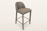 Gavi upholstered counter stool in brown, three-quarter view on a warm white studio backdrop