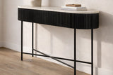 Gideon black reeded console table with white marble top against a hallway wall