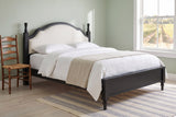 Gradara bed in black in a sage-green guest room with a striped rug