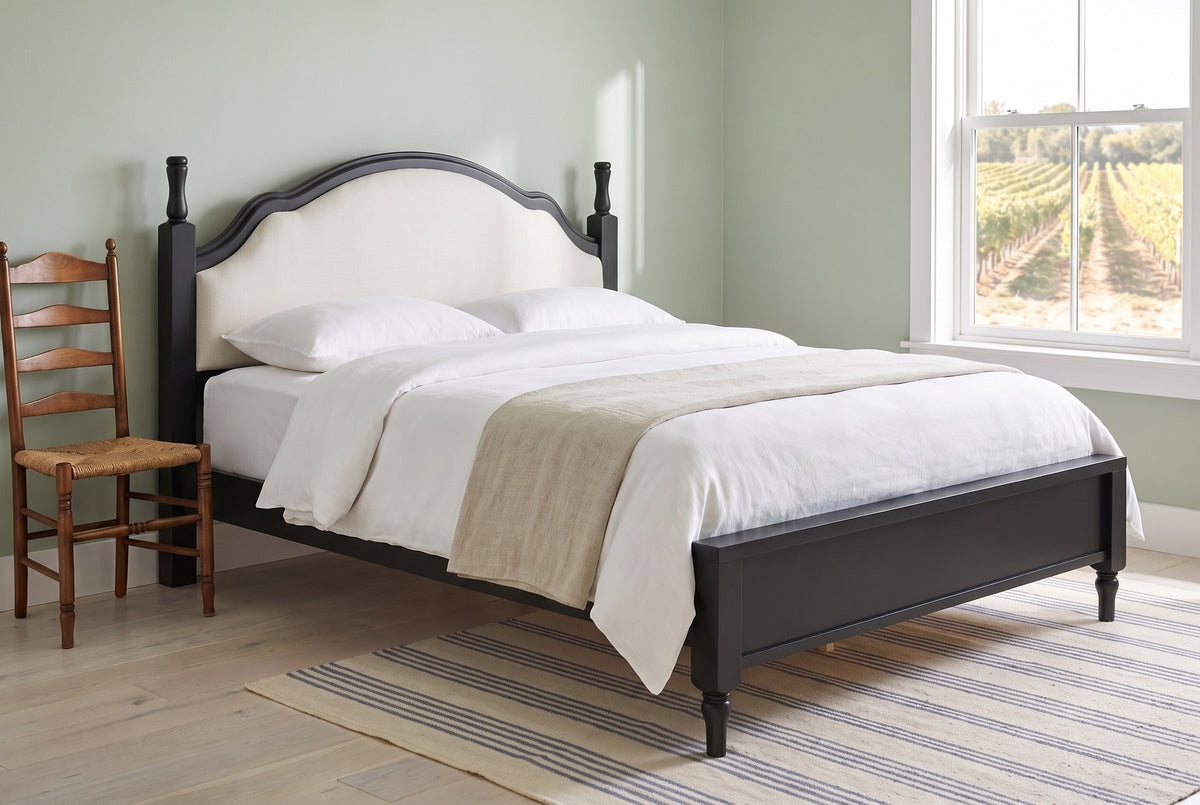 Gradara bed in black in a sage-green guest room with a striped rug