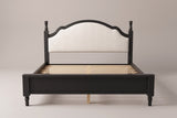 Gradara bed in black, straight front view: arched upholstered headboard between two turned finial posts