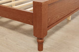Close-up of the Gradara footboard corner: flat cap, square post, framed panel and a turned foot on a pale oak floor