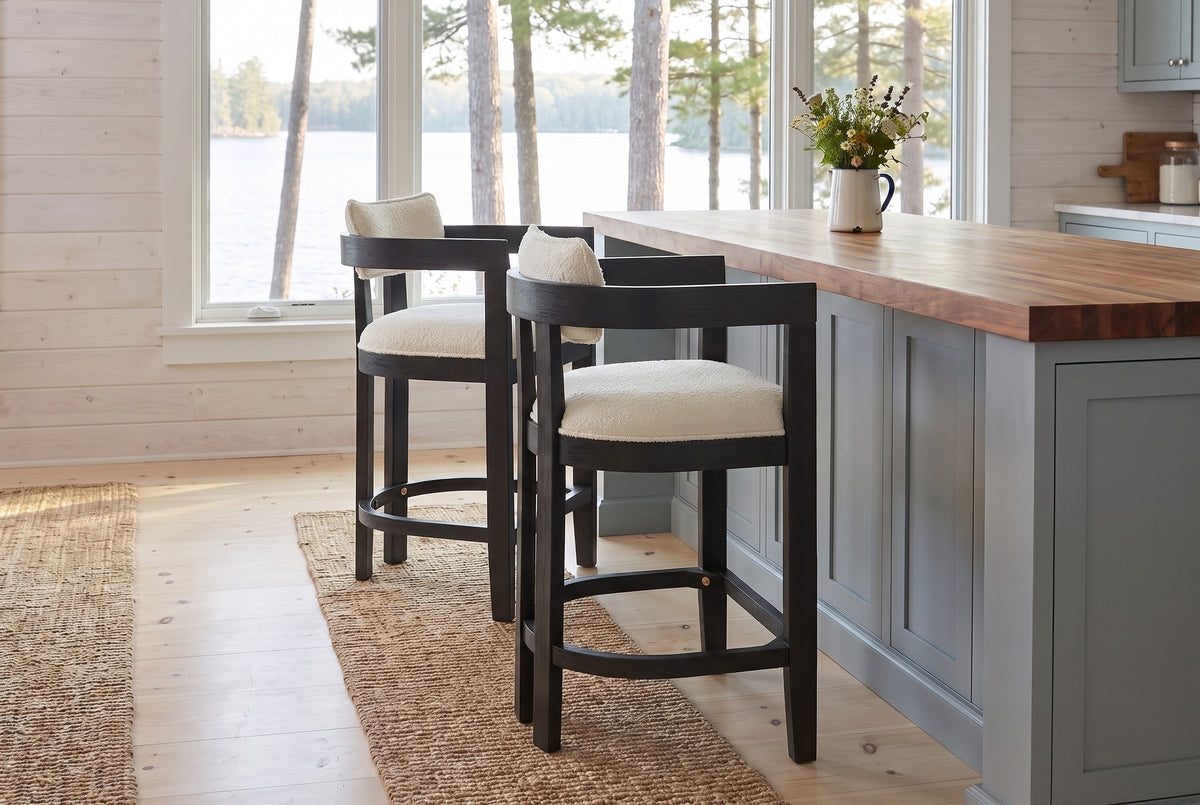 Two Gradisca counter stools in Black at a butcher-block island in a Muskoka cottage kitchen with a window onto the lake