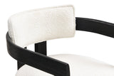 Close-up of the Gradisca floating back pad, the curved wooden rail and the piped seat: ivory boucle on the Black frame