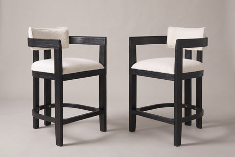 Gradisca counter stools, set of 2, in Black with ivory boucle, angled toward each other on a warm grey studio backdrop