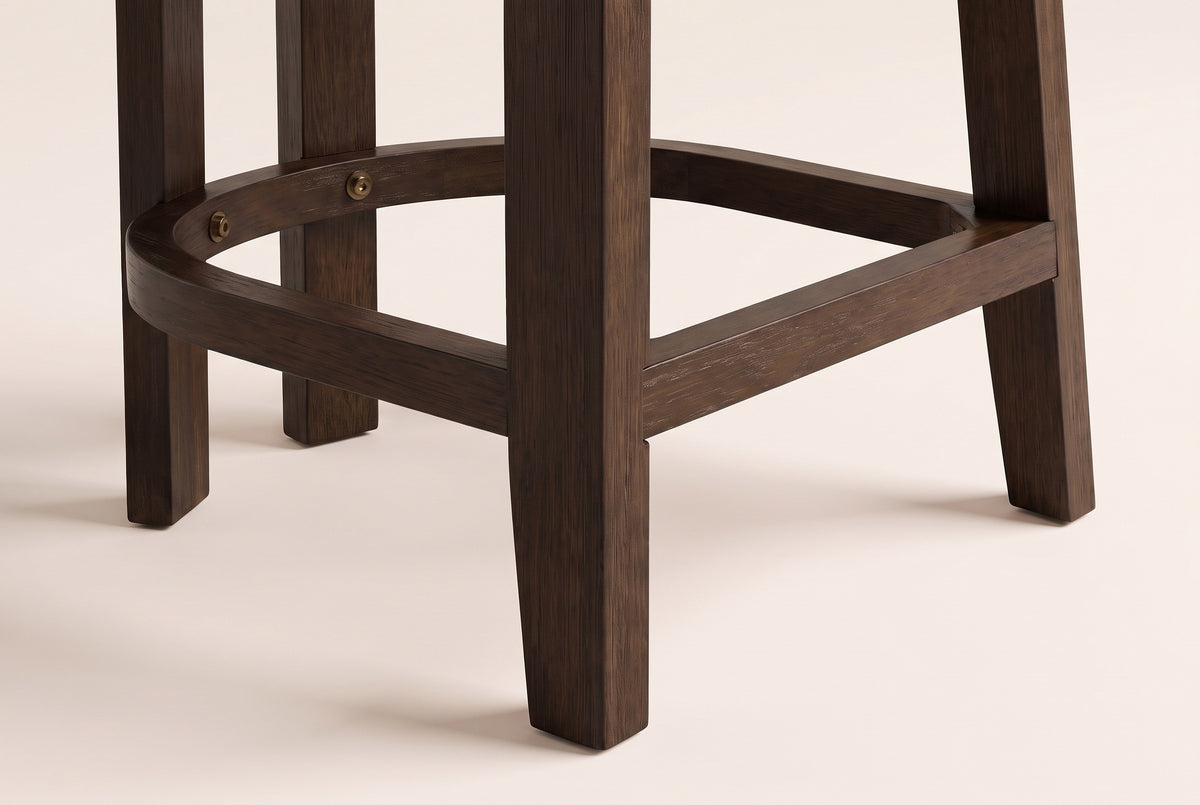 Close-up of the Gradisca front leg, rear legs and D-shaped footring with two small brass-tone bolts in Espresso