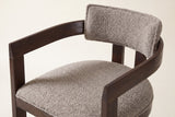 Close-up of the Gradisca floating back pad, the curved wooden rail and the piped seat: taupe boucle on the Espresso frame