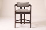 Gradisca horseshoe counter stool in Espresso with taupe boucle, straight front view on a studio backdrop