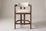 Gradisca horseshoe counter stool in Walnut, straight front view on a studio backdrop