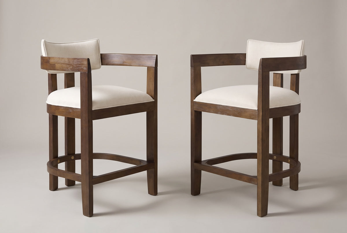 Gradisca counter stools, set of 2, in Walnut with ivory woven fabric, angled toward each other on a warm grey studio backdrop