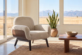 Grado chair in oat on a jute rug in a Calgary foothills living room with windows onto grassland and the Rockies