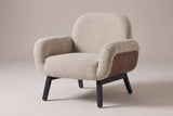 Grado shell-arm accent chair in oat chenille-look fabric, three-quarter view on a warm grey studio backdrop