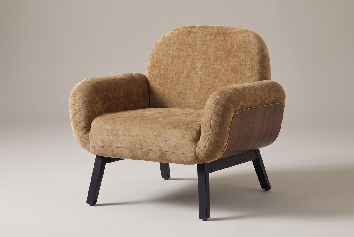 Grado shell-arm accent chair in tan chenille-look fabric, three-quarter view on a warm grey studio backdrop