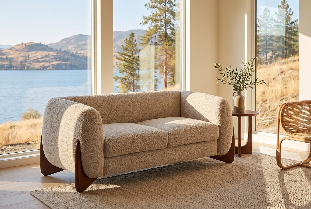 Greccio boucle loveseat in a lake house living room with a lake and golden hills behind the windows