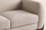 Close-up of the almond boucle seat cushion, the rounded arm and the back of the Greccio loveseat