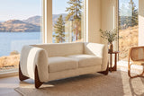 Greccio boucle loveseat in beige in a lake house living room with a lake and golden hills behind the windows