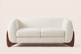 Greccio boucle loveseat in beige, straight front view with two seat cushions and walnut-stained wedge legs