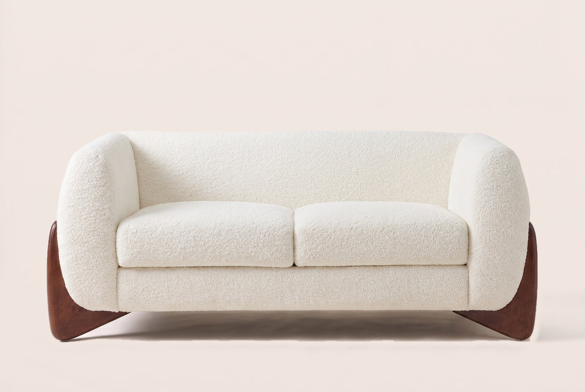 Greccio boucle loveseat in beige, straight front view with two seat cushions and walnut-stained wedge legs