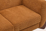 Close-up of the caramel boucle seat cushion, the rounded arm and the back of the Greccio loveseat
