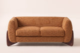Greccio boucle loveseat in caramel, straight front view with two seat cushions and walnut-stained wedge legs