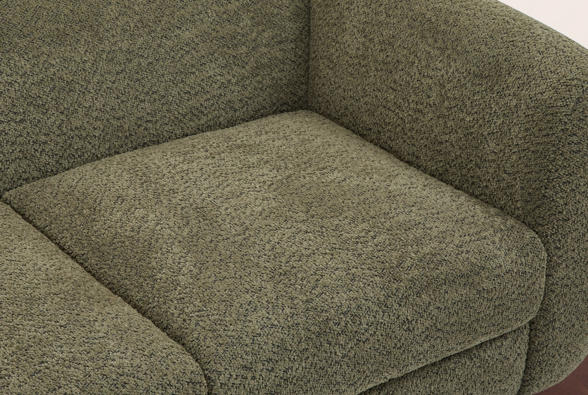 Close-up of the olive green boucle seat cushion, the rounded arm and the back of the Greccio loveseat