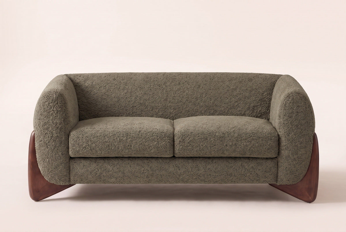 Greccio boucle loveseat in olive green, straight front view with two seat cushions and walnut-stained wedge legs