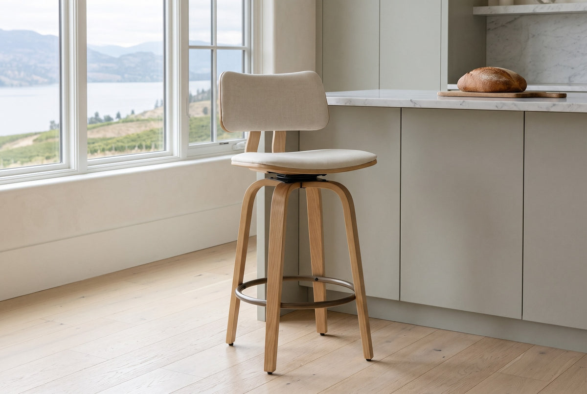 A Gressoney counter stool in Beige / Natural beside a sage-grey kitchen island in a lakeside house in Kelowna, vineyard hills and Okanagan Lake through the window