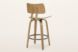 Gressoney counter stool in Beige / Natural from behind: the natural-finish back panel and two supports with six round brass-tone screw caps