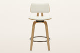 Gressoney counter stool in Beige / Natural, straight front view: the padded fabric back cushion on its curved oak-finish panel, the two back supports, the seat, four bent legs and the round footrest