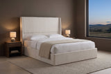 Greve wingback bed in a taupe bedroom at dusk with two lit lamps and rolling foothills through a wide window
