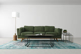 Hadrian floor lamp at the end of a green sofa in a living room
