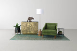 Hadrian floor lamp between a brass-clad cabinet and a green armchair