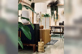 Hadrian floor lamp with reeded wood base beside a leather chair in a styled room