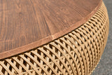 Close-up of the Halden reclaimed teak top edge over the handwoven rattan base