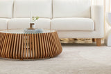 Hartley round coffee table in front of a white boucle sofa